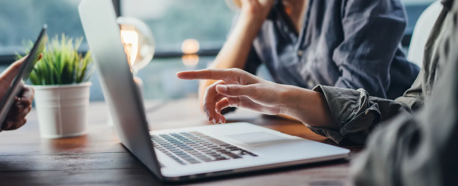 a man and a woman working on a laptop