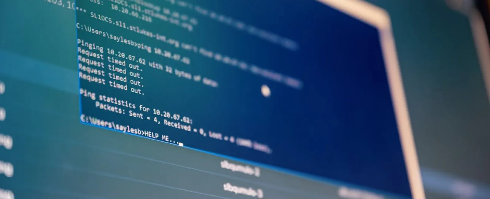 Computer screen displaying command prompt with network ping commands and timeout results.