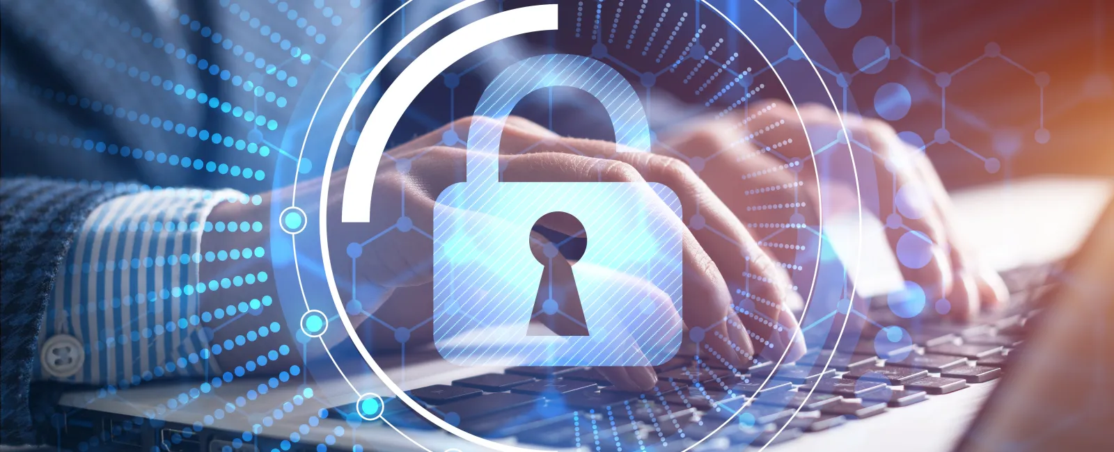 Hands typing on laptop keyboard with digital padlock and security interface overlay for cybersecurity concept