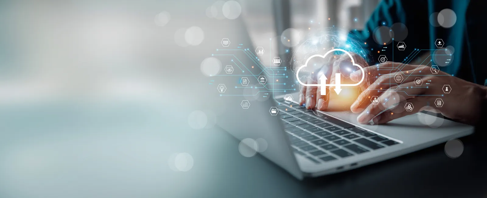Person using laptop with cloud computing and data icons illustrating digital networking technology.