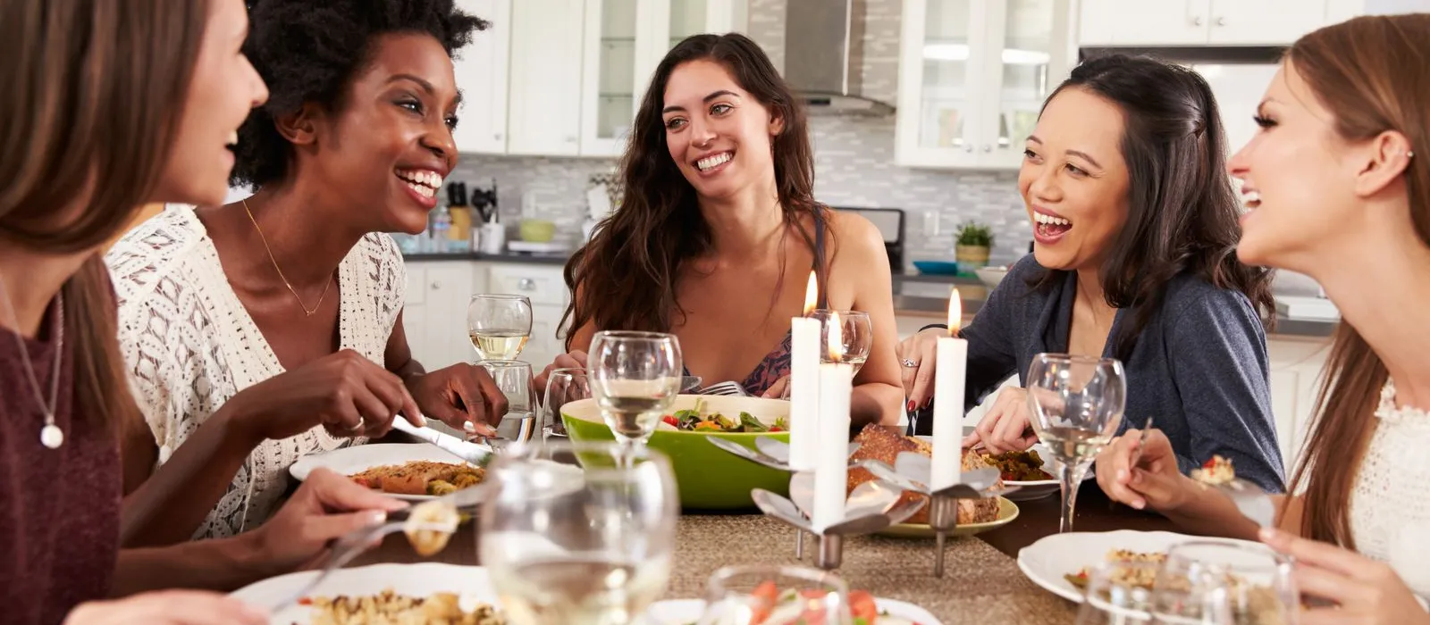 a group of women eating at a dinner table