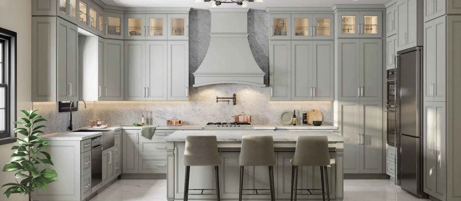 Modern gray kitchen with marble countertops, large island with stools, stainless steel appliances, and overhead lighting