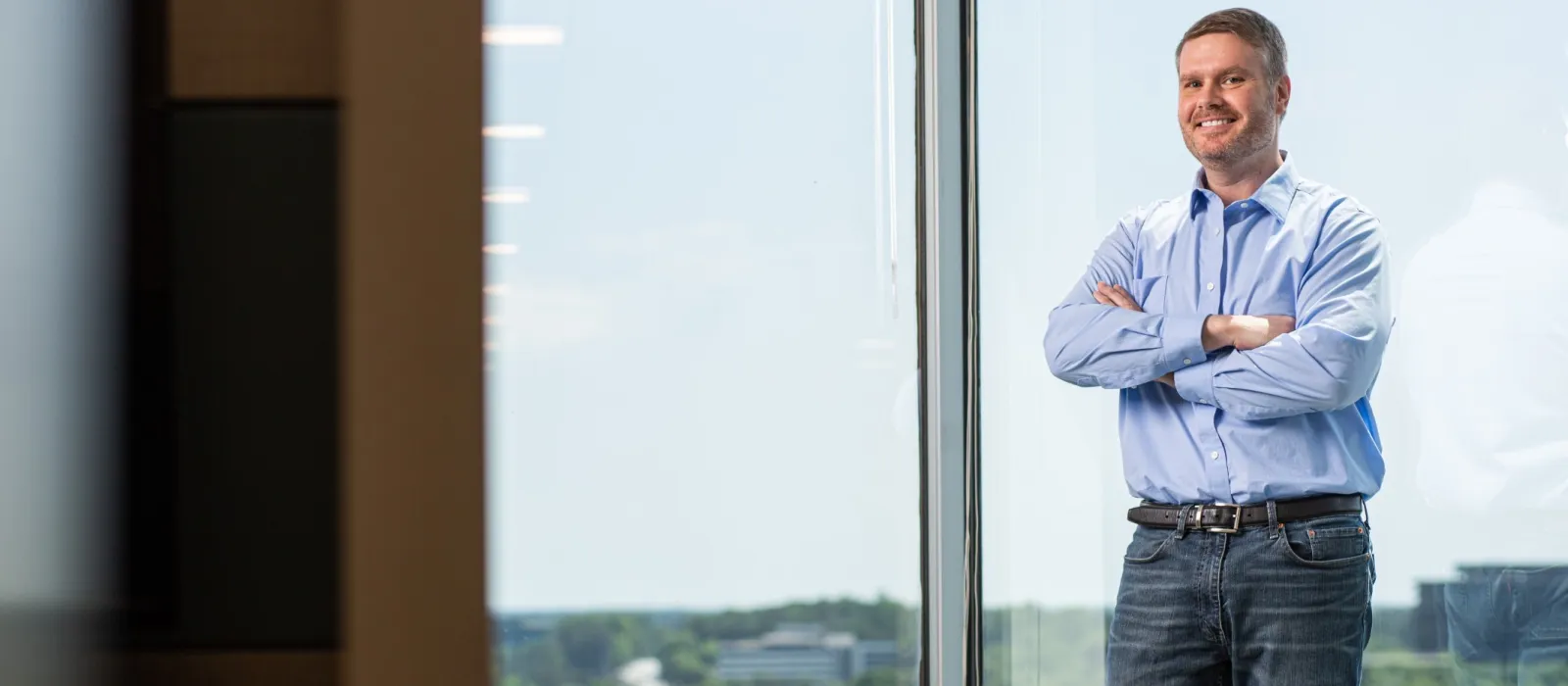 a man standing in front of a window