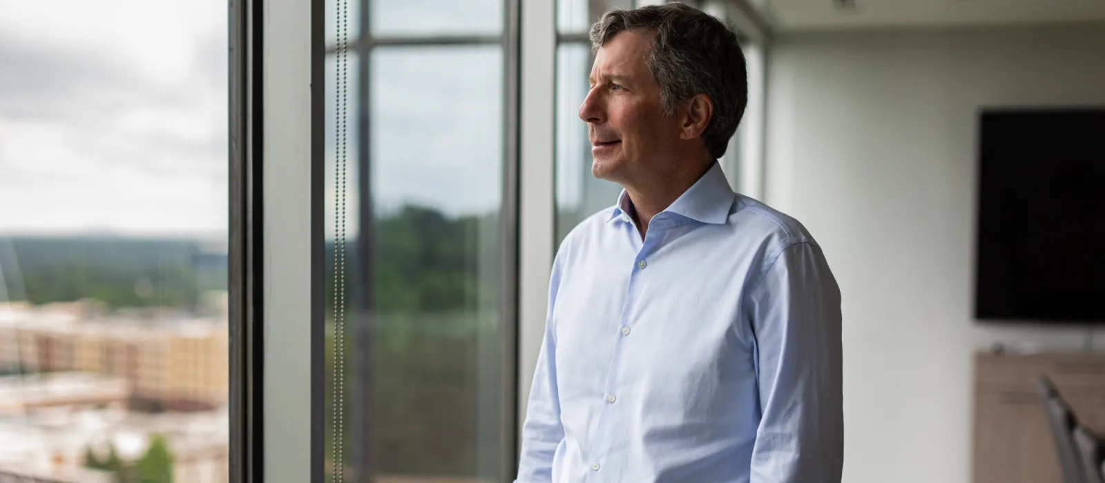 a man standing in front of a window