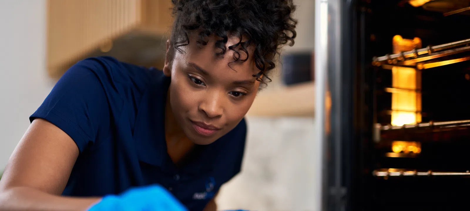 MaidPro Baltimore house cleaning professional cleaning an oven