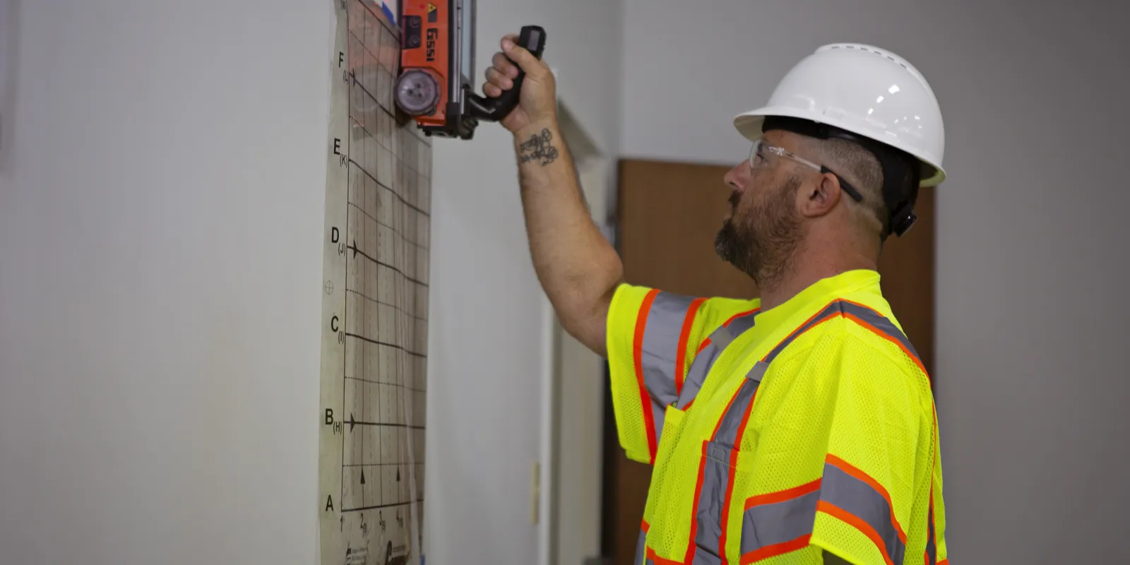 Man with Blood Hound hard hat performing Concrete Scanning service