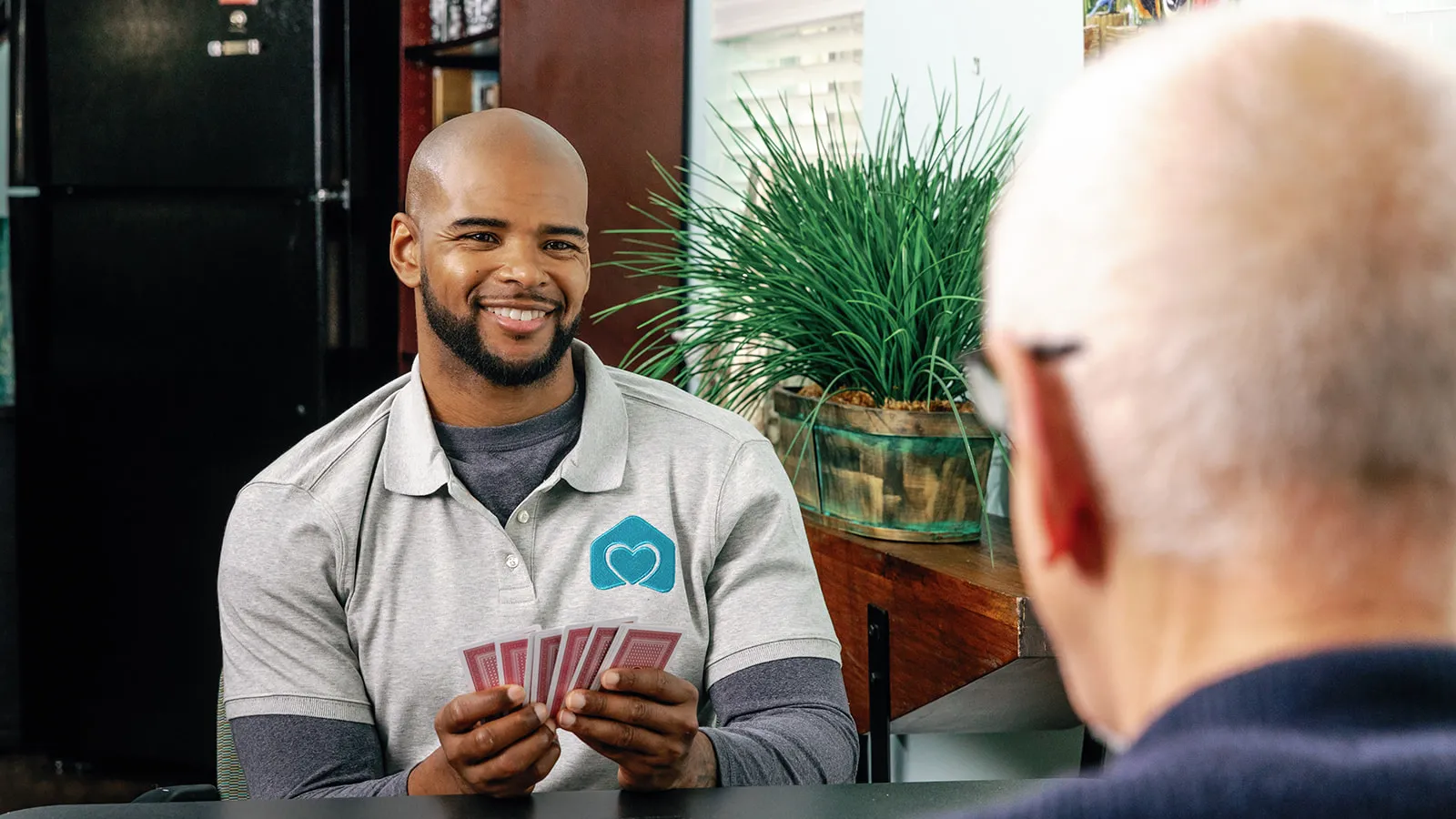 a man holding a card and another man looking at him