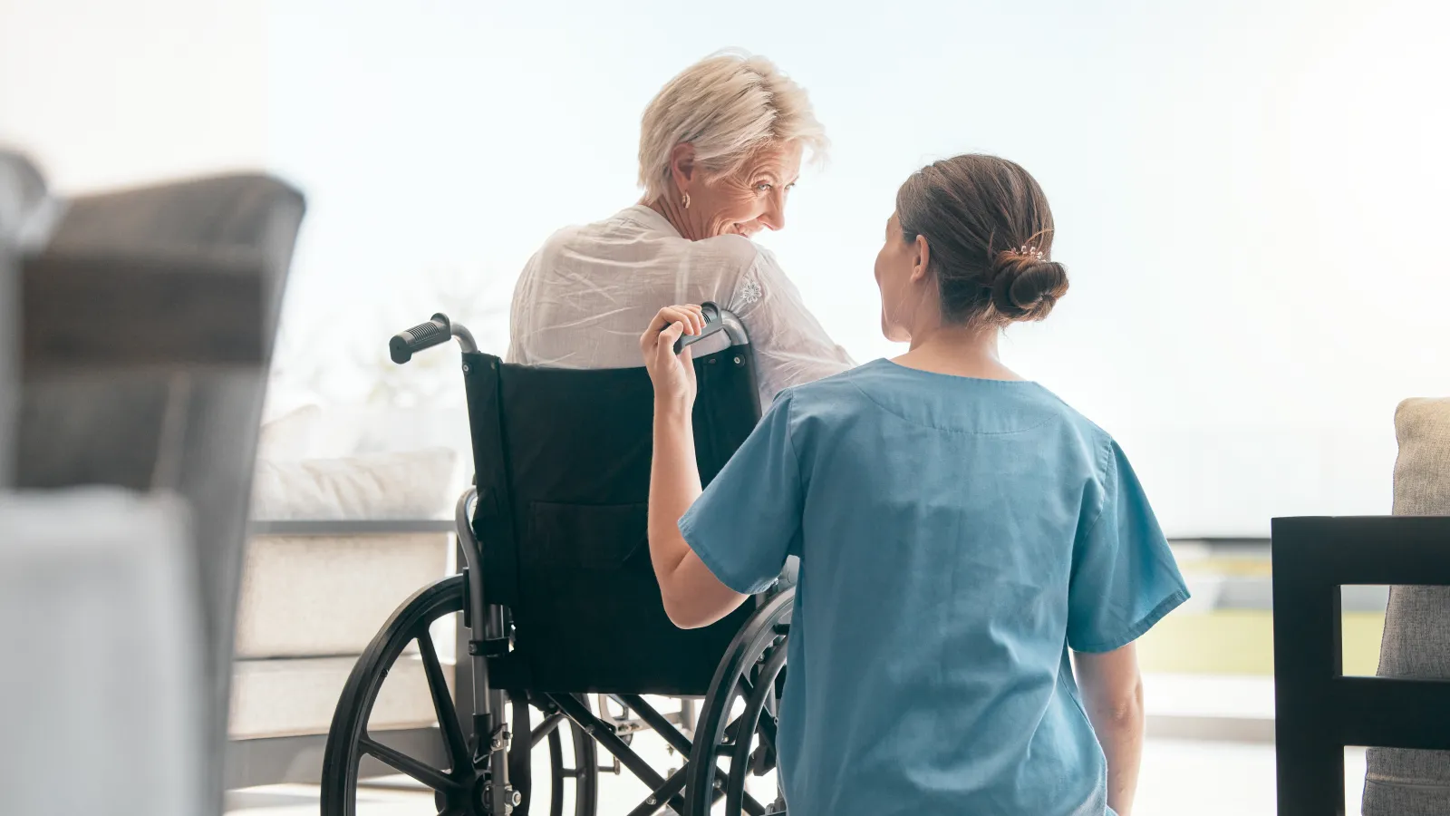a woman in a wheelchair looking at a woman in a wheelchair