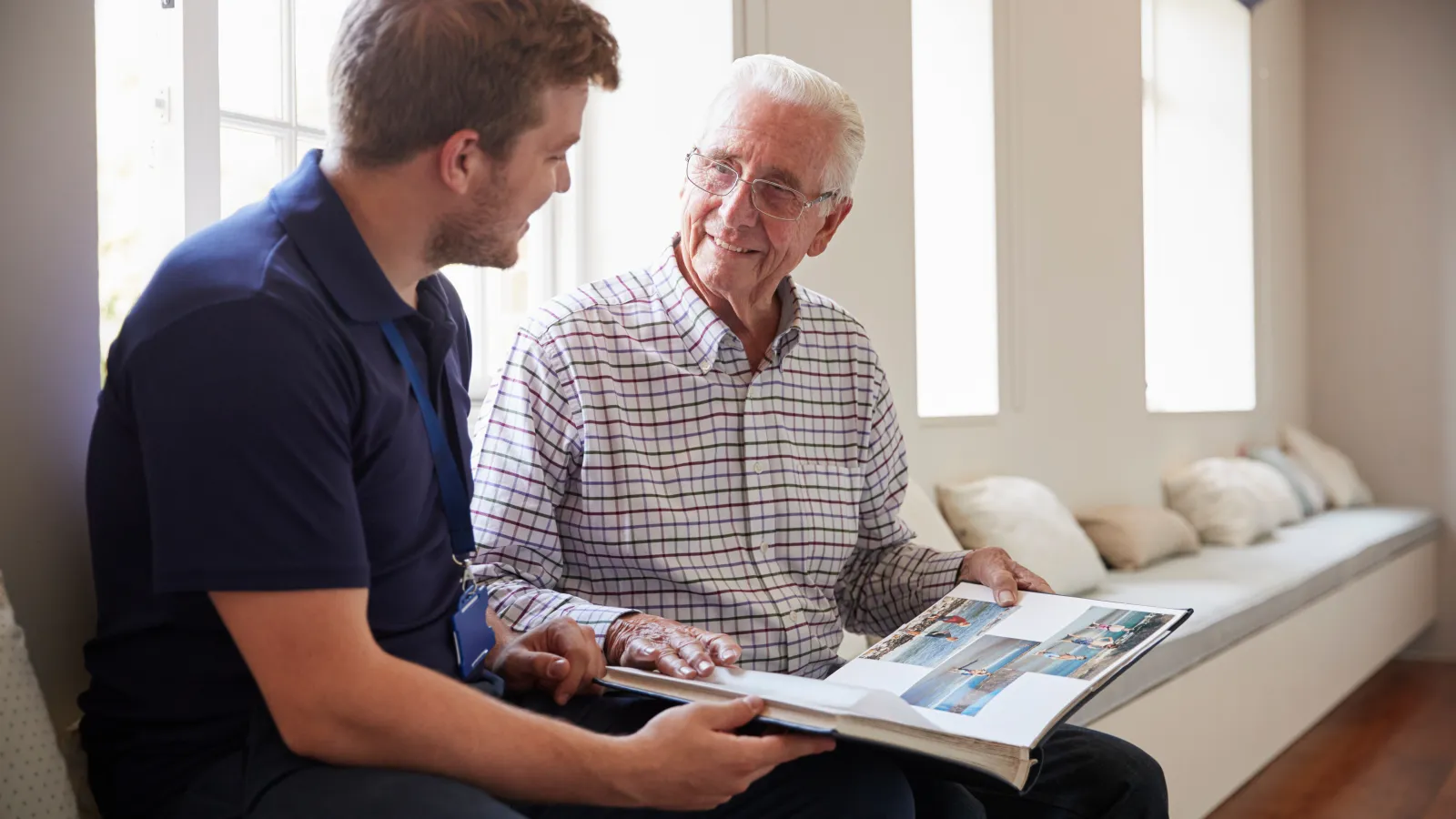 a man reading a book to an old man