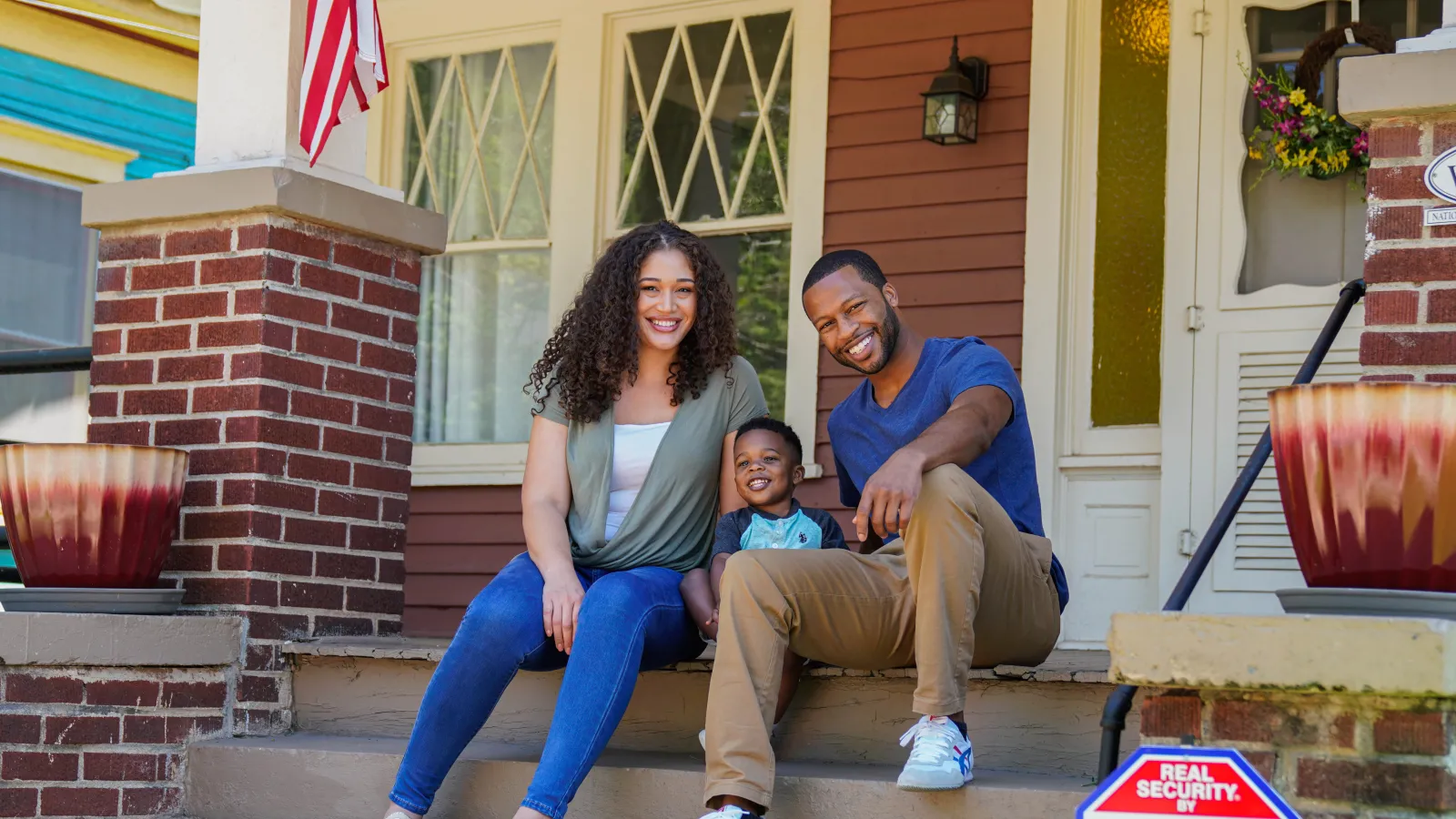 Byron Mulkey et al. sitting on a porch with a child