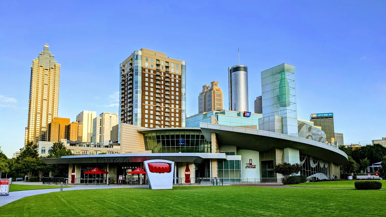 a large building with a green lawn