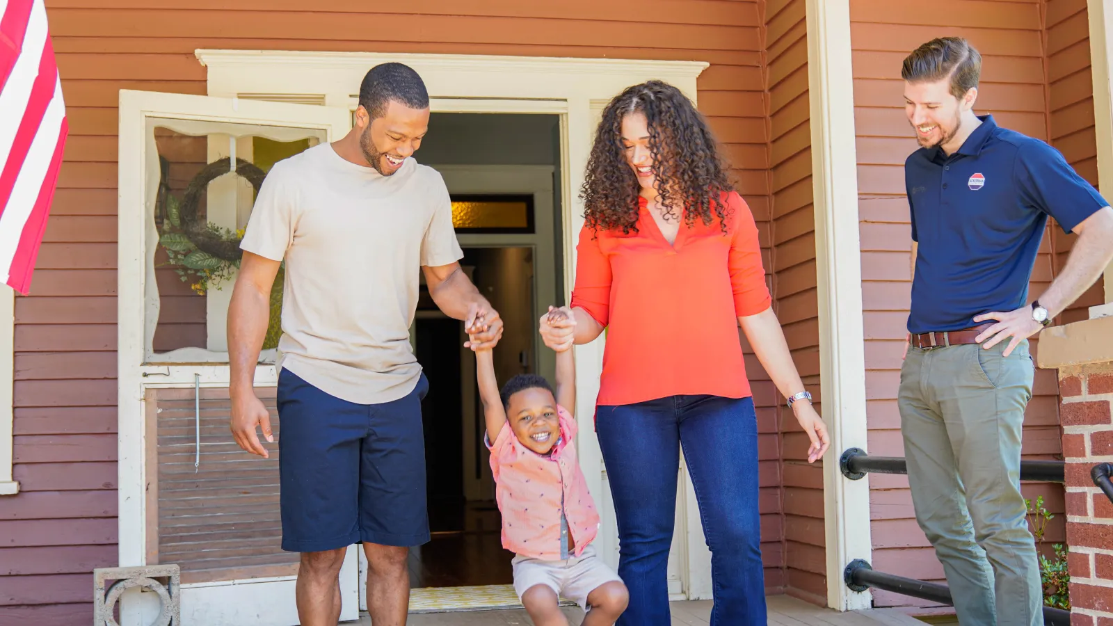 a family walking out of a house