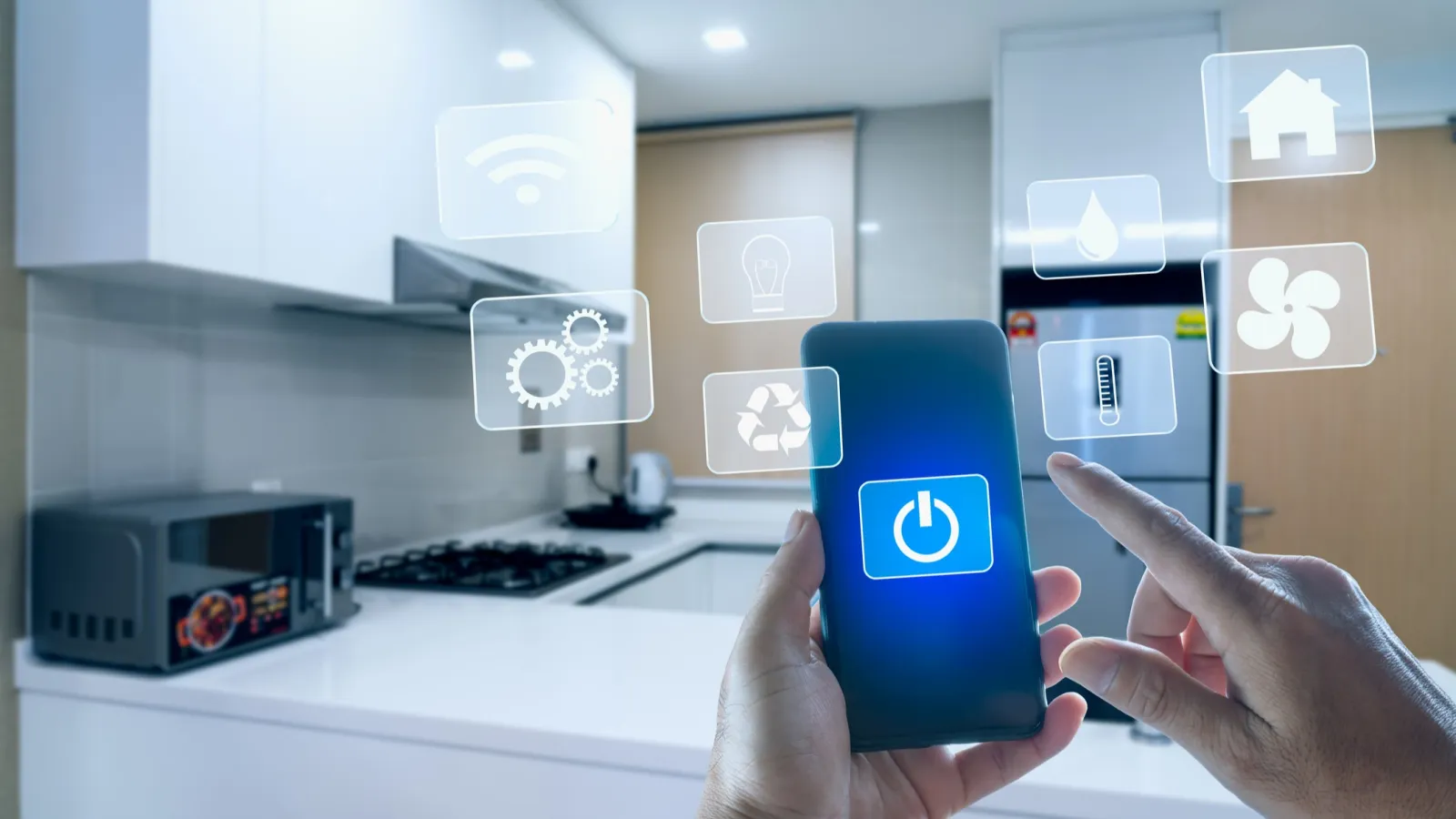 Person using smartphone to control smart home appliances in modern kitchen with digital interface icons.
