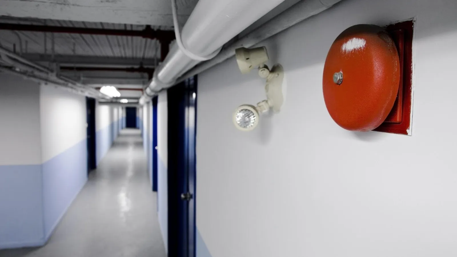 a hallway with an alarm on the wall