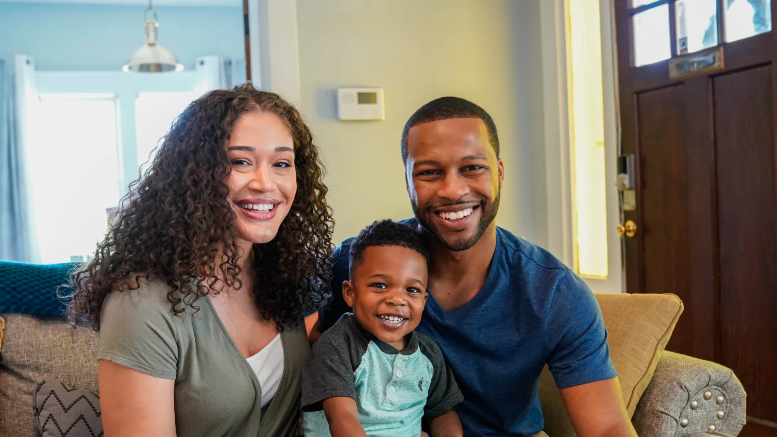 a family sitting on a couch