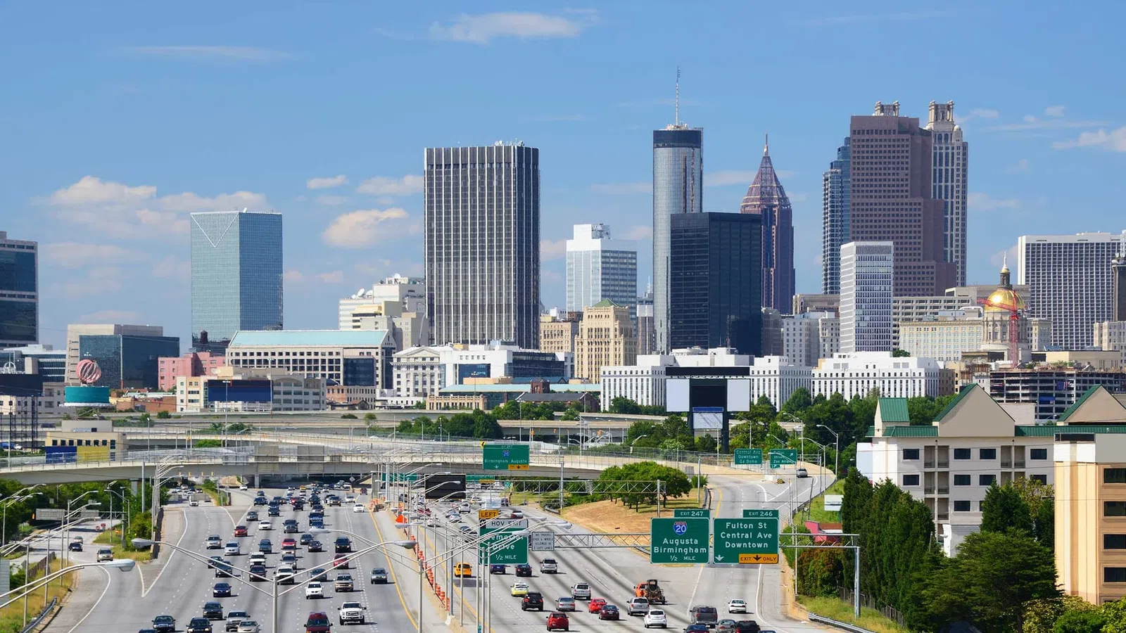 Atlanta skyline featuring modern skyscrapers under a clear blue sky with busy highways
