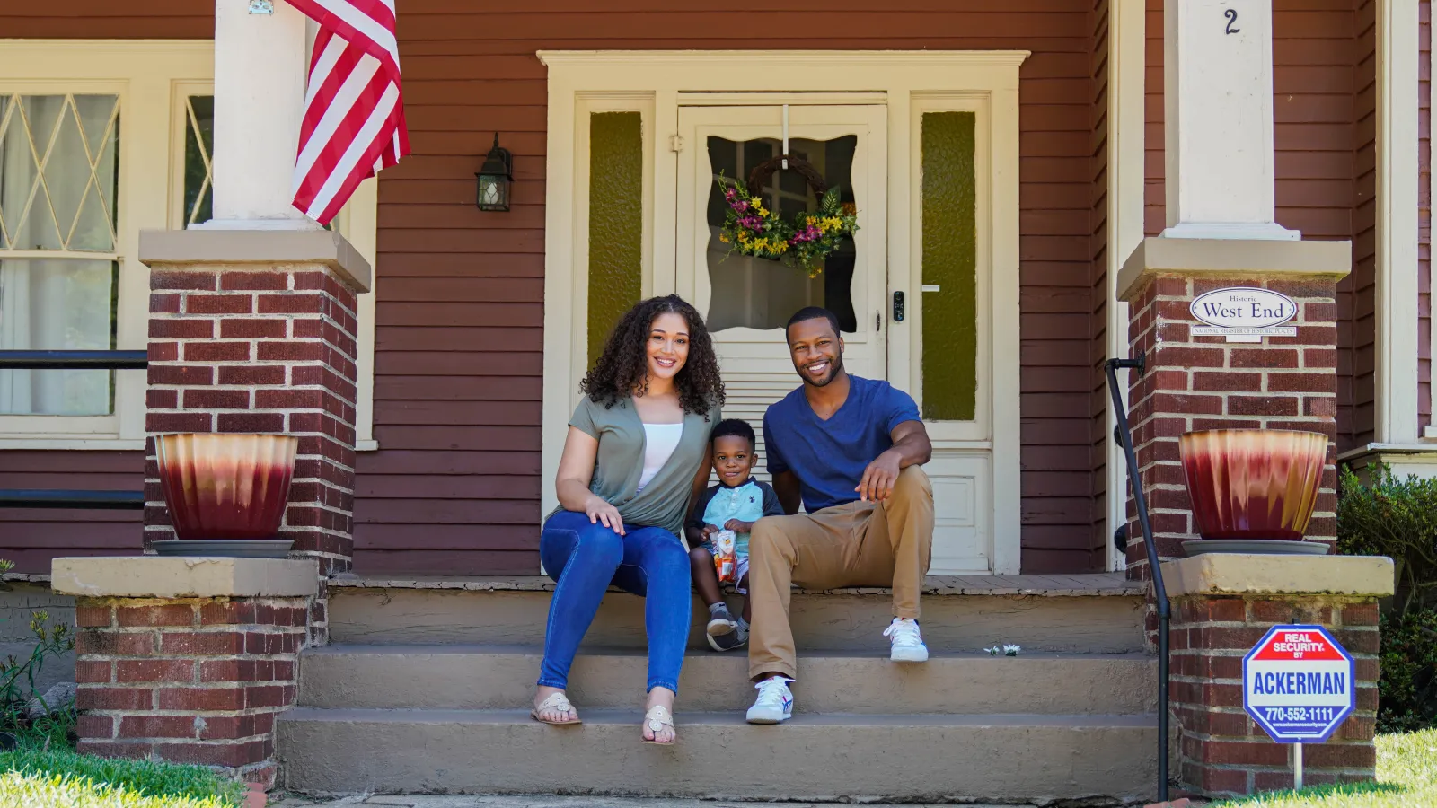 a family sitting on steps outside a house