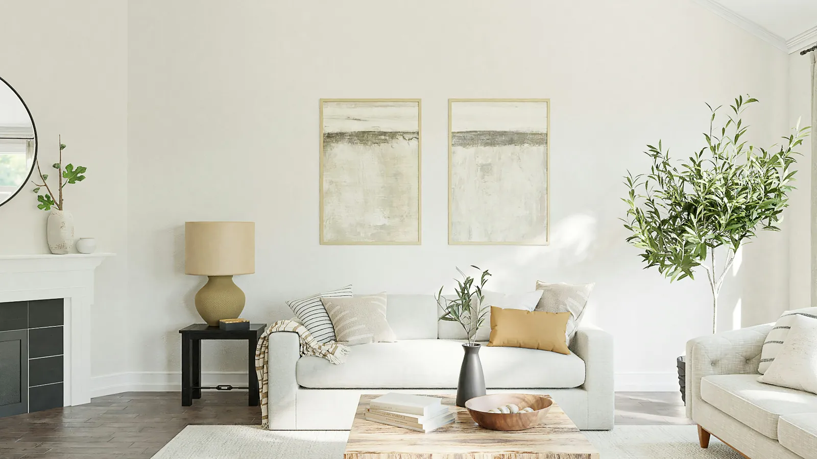 a living room with a white couch and a white wall with art on it