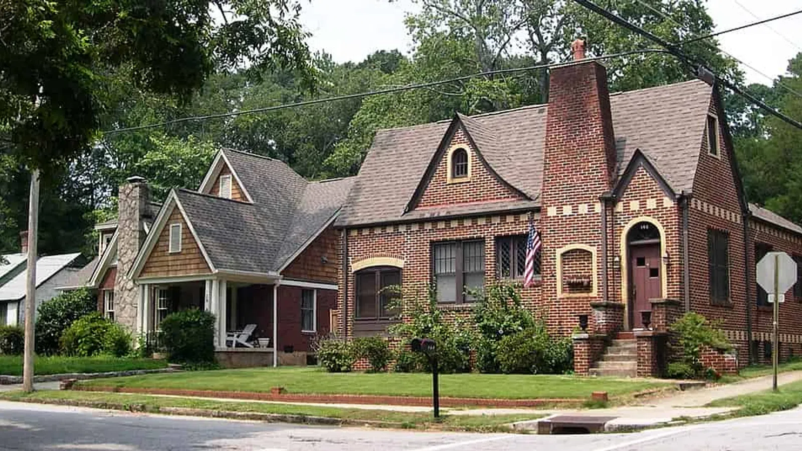 Charming brick homes with traditional architecture and lush green surroundings in a neighborhood setting.