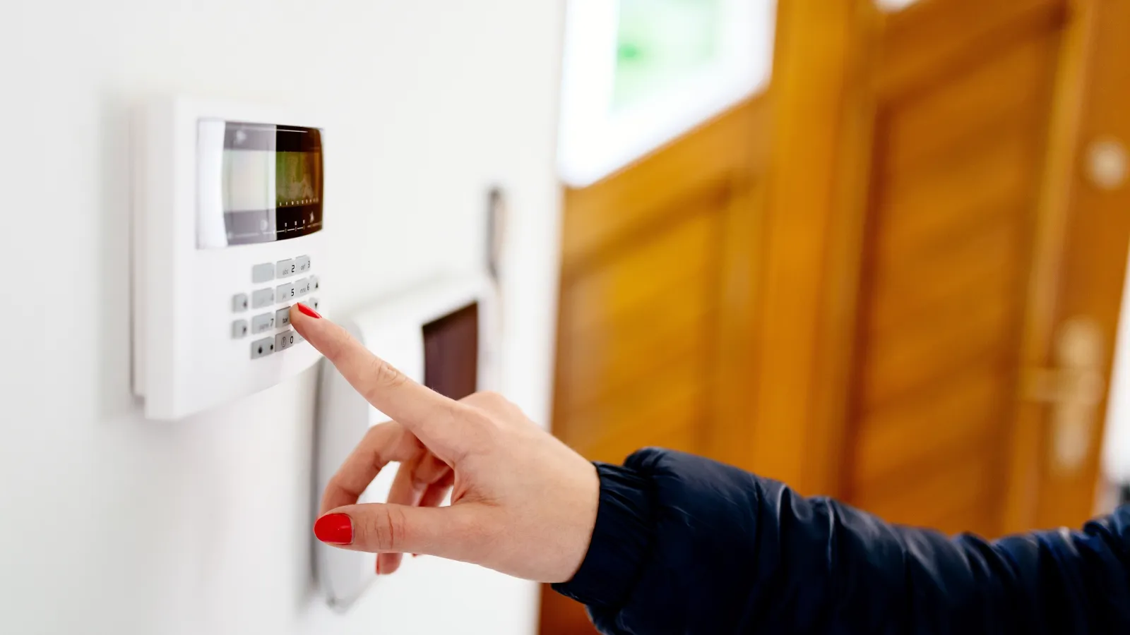 a hand pointing at a microwave