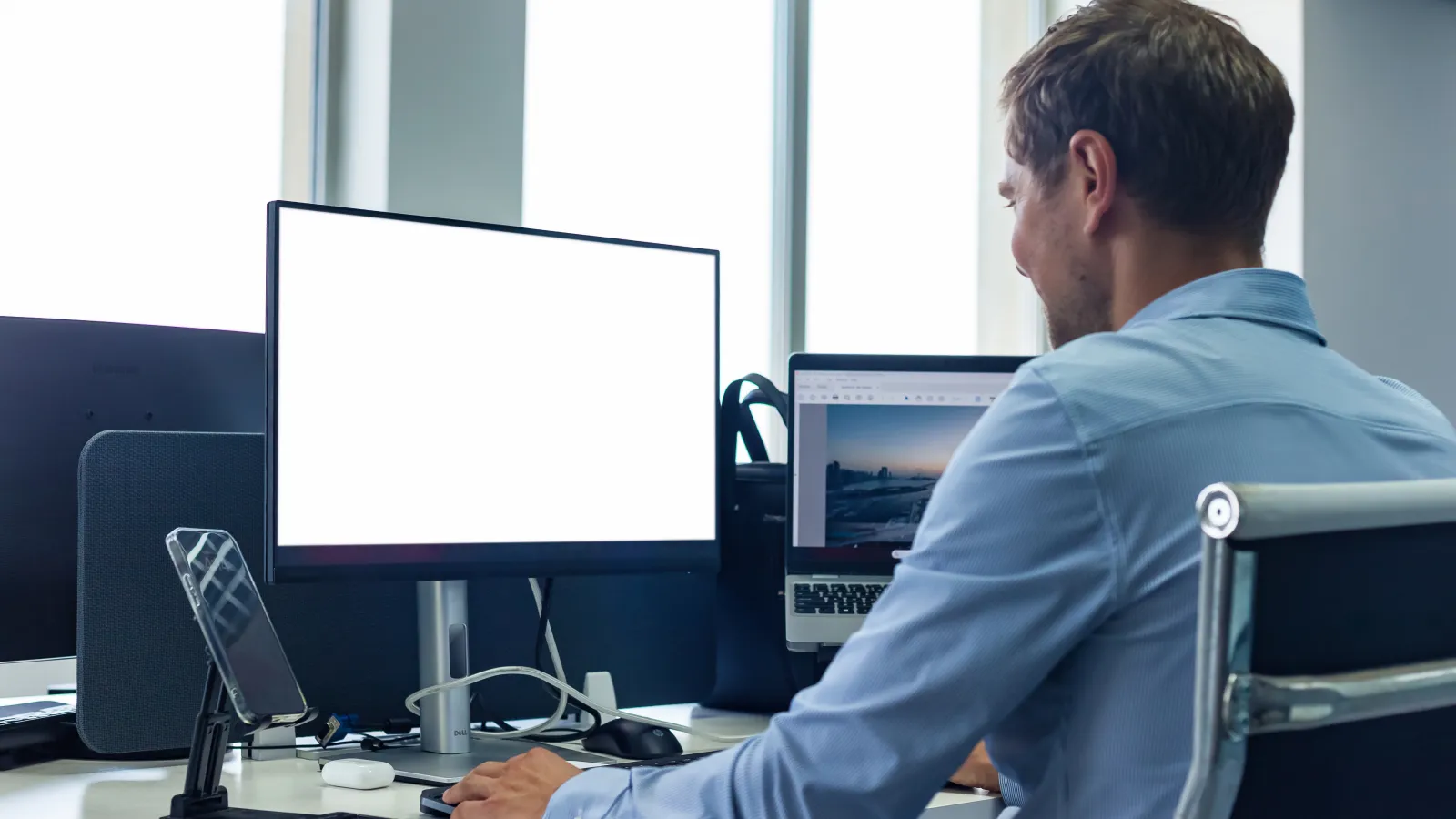 a man sitting at a desk with a computer