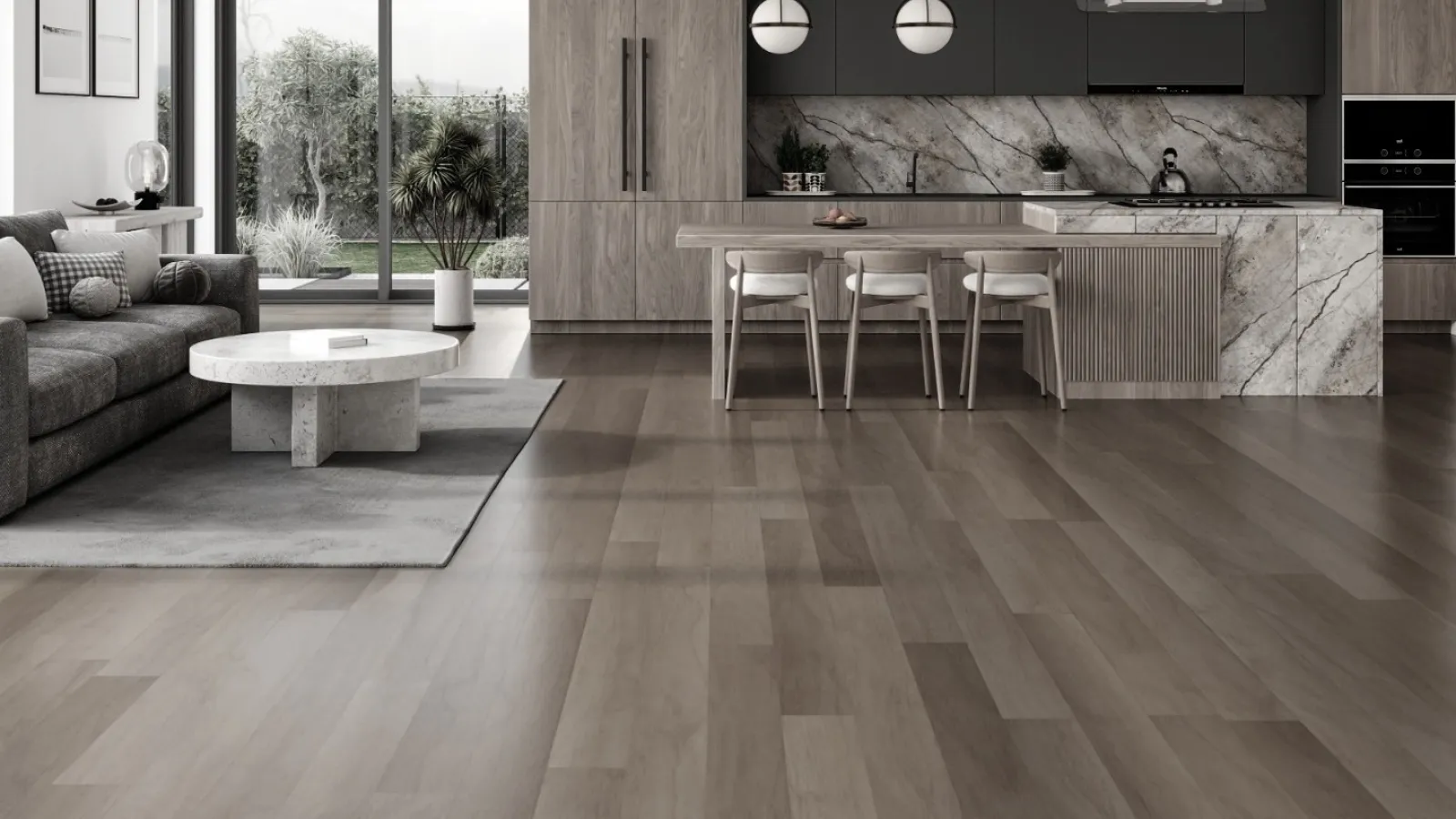 Modern open-concept living room and kitchen with gray sofa, marble island, large windows, and wood flooring.