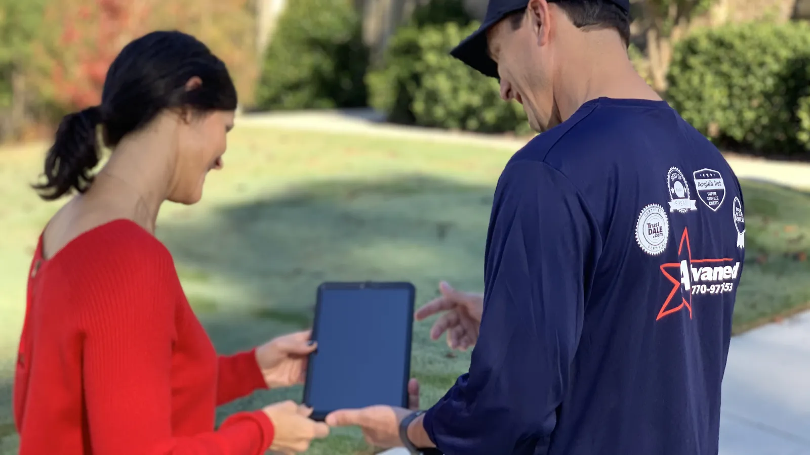 a man and a woman holding a tablet