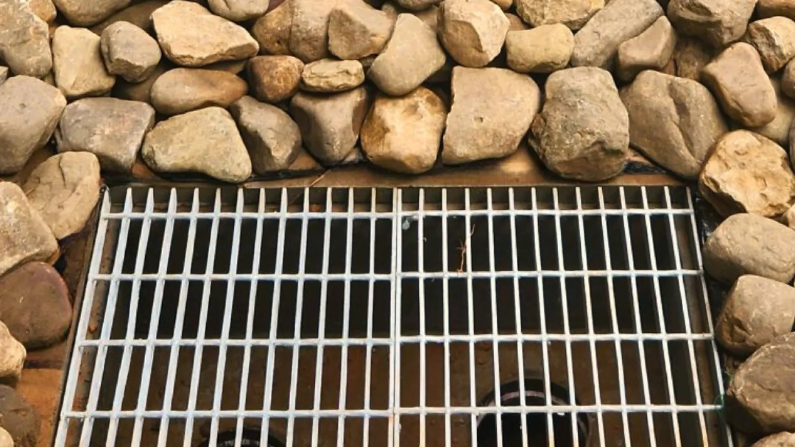 a grill in a rocky area