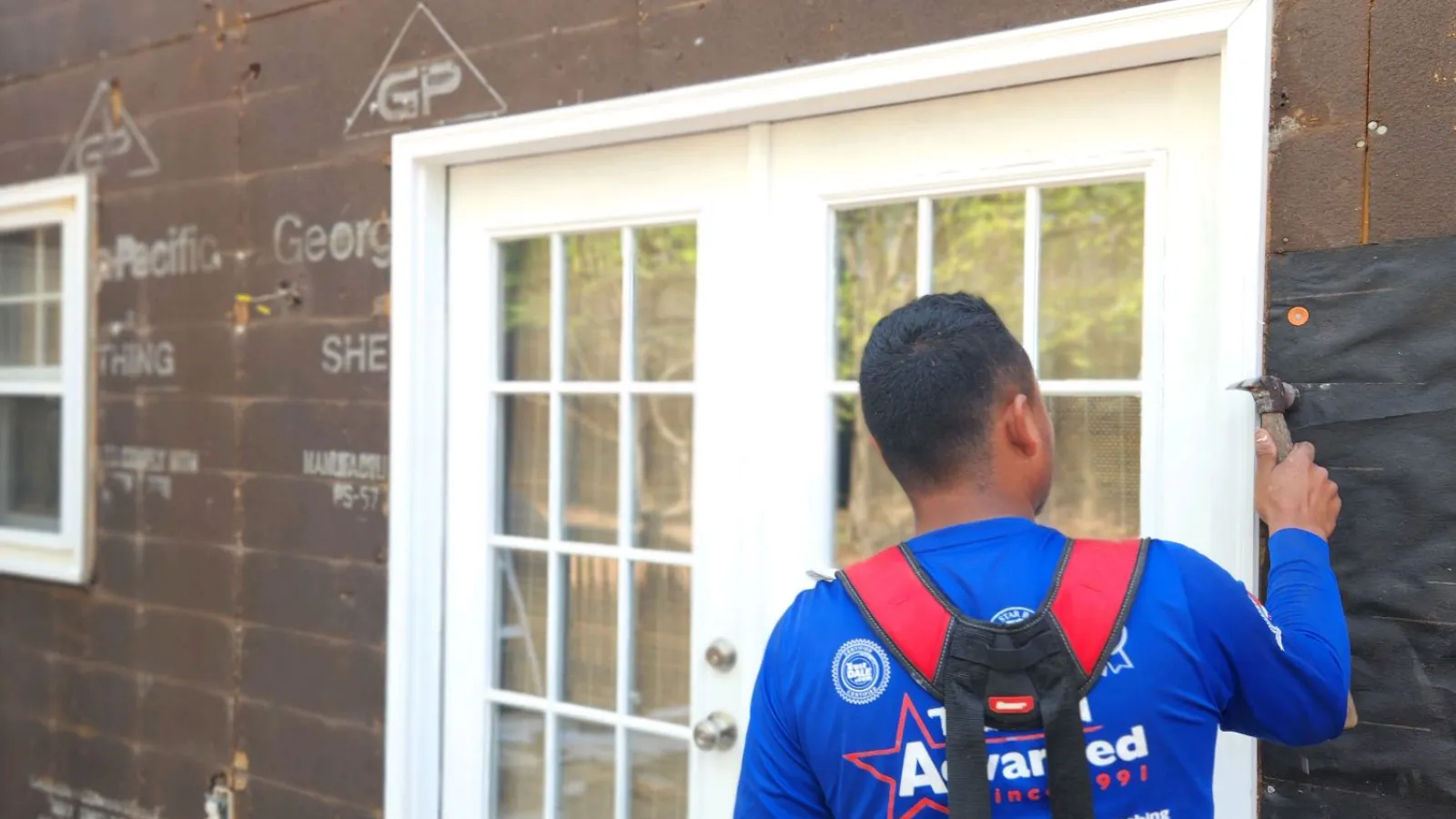 a person with a backpack looking at a window