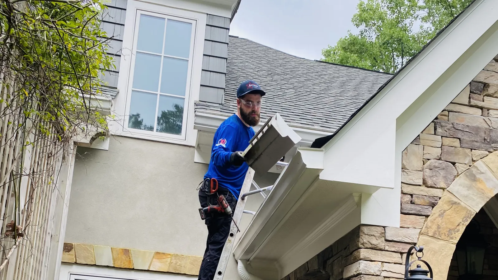 a man and a woman on a ladder on a house