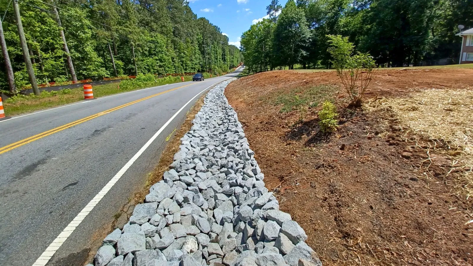 a road with rocks and trees on the side