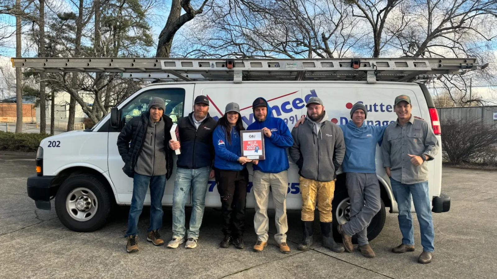 a group of people standing in front of a truck