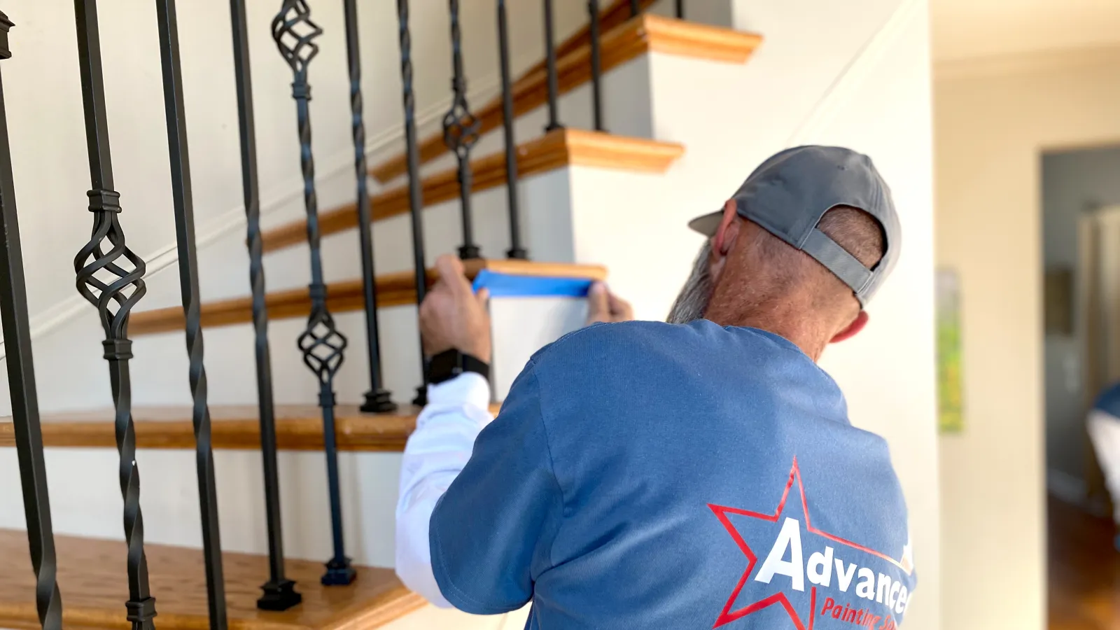 a man painting a staircase