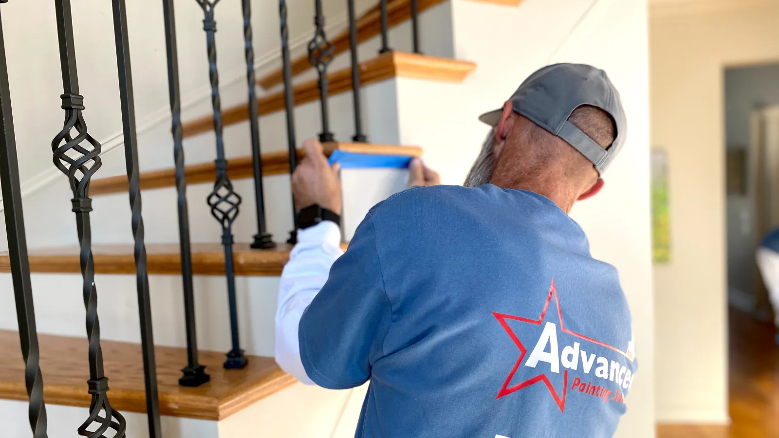 a man painting a staircase