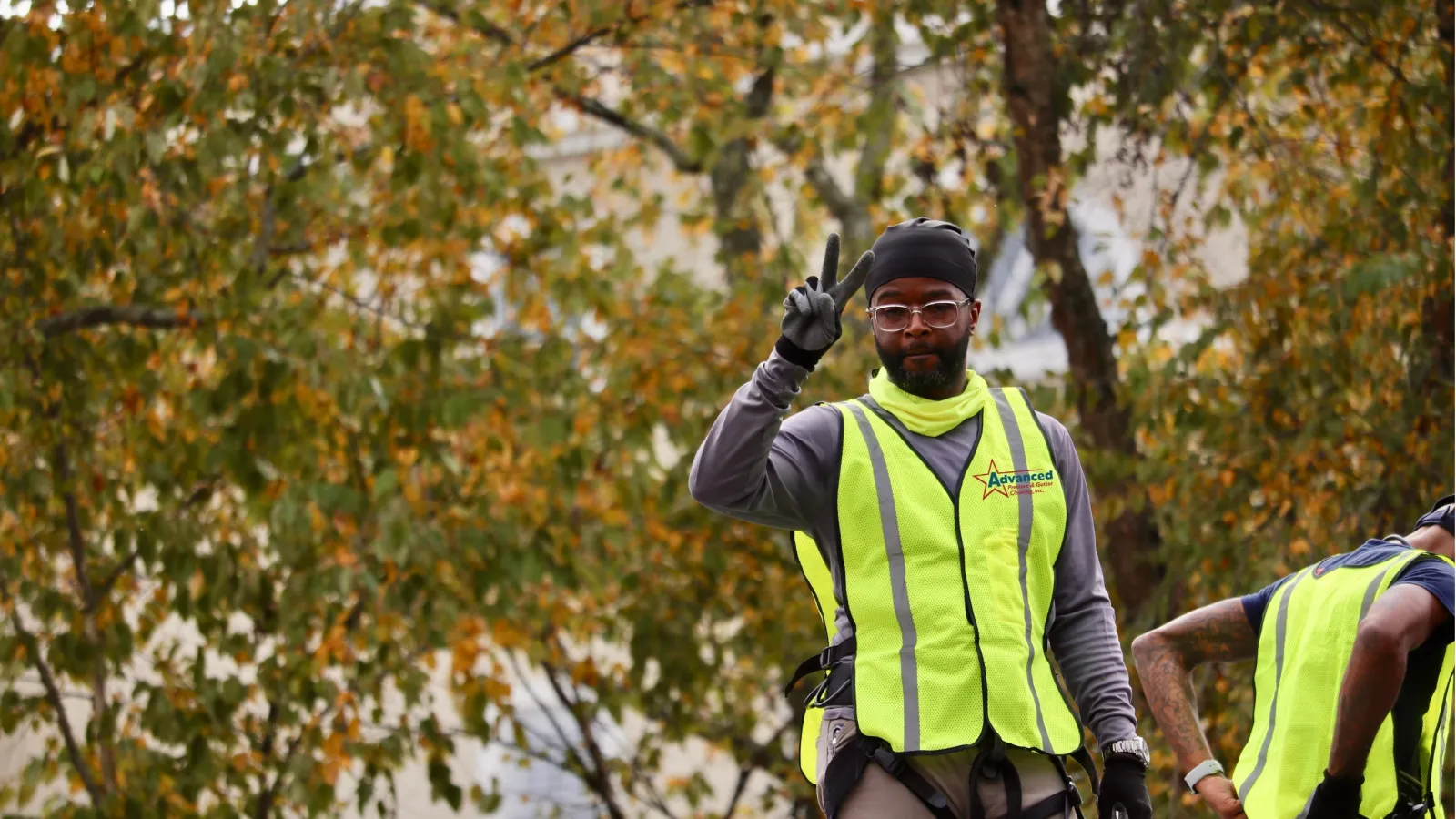 Commercial gutter cleaner in safety vest and gloves in Atlanta, GA