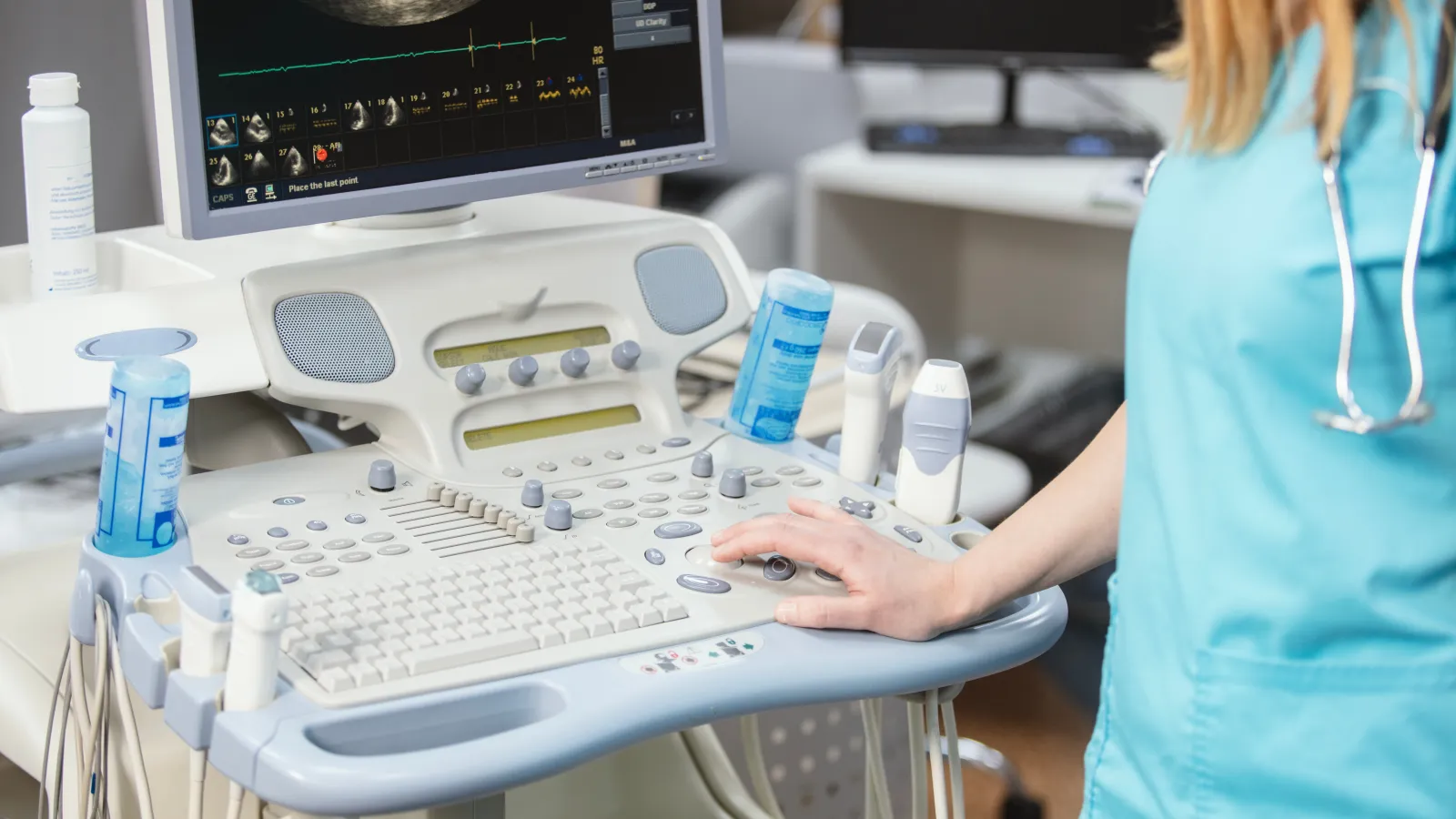 a person in a medical scrubs working on a computer