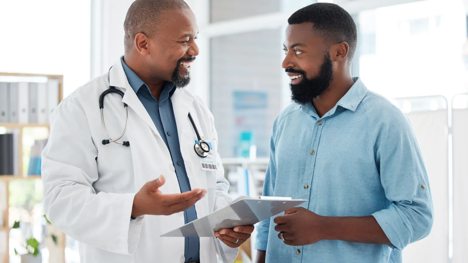 a doctor showing a patient something on the paper