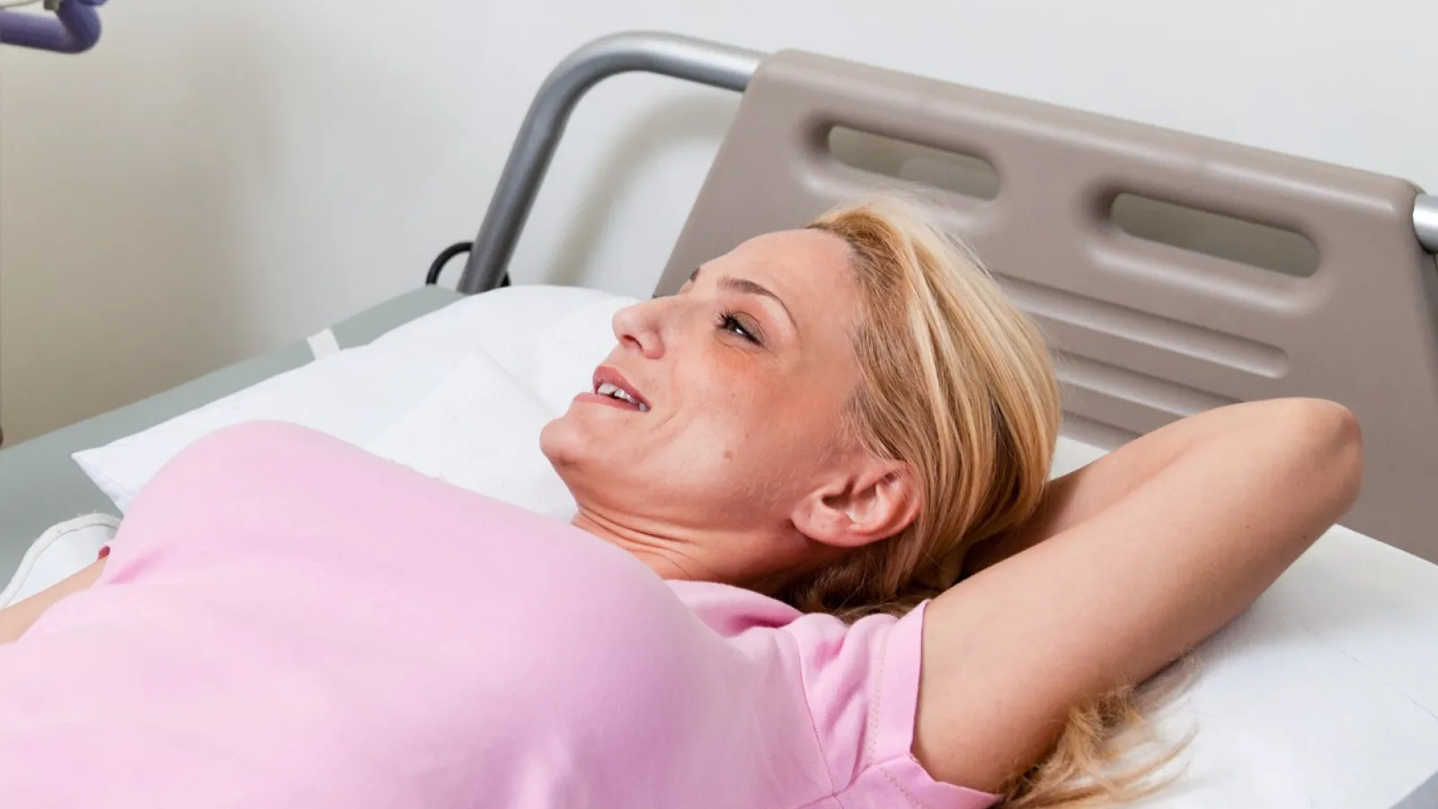 a person lying in a hospital bed
