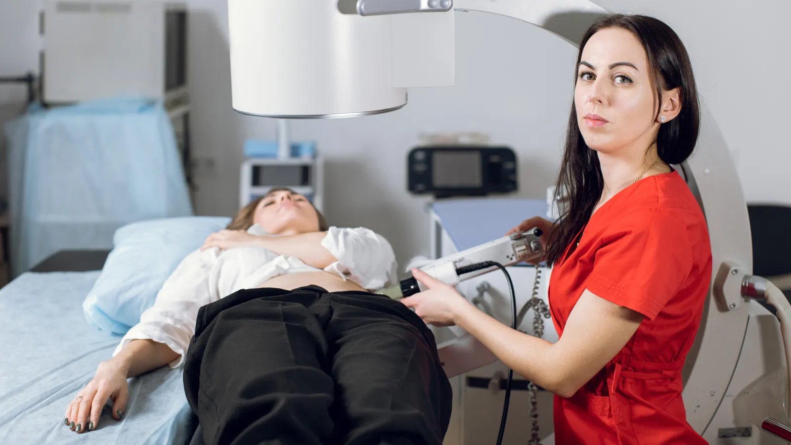 a woman standing next to a man in a hospital bed