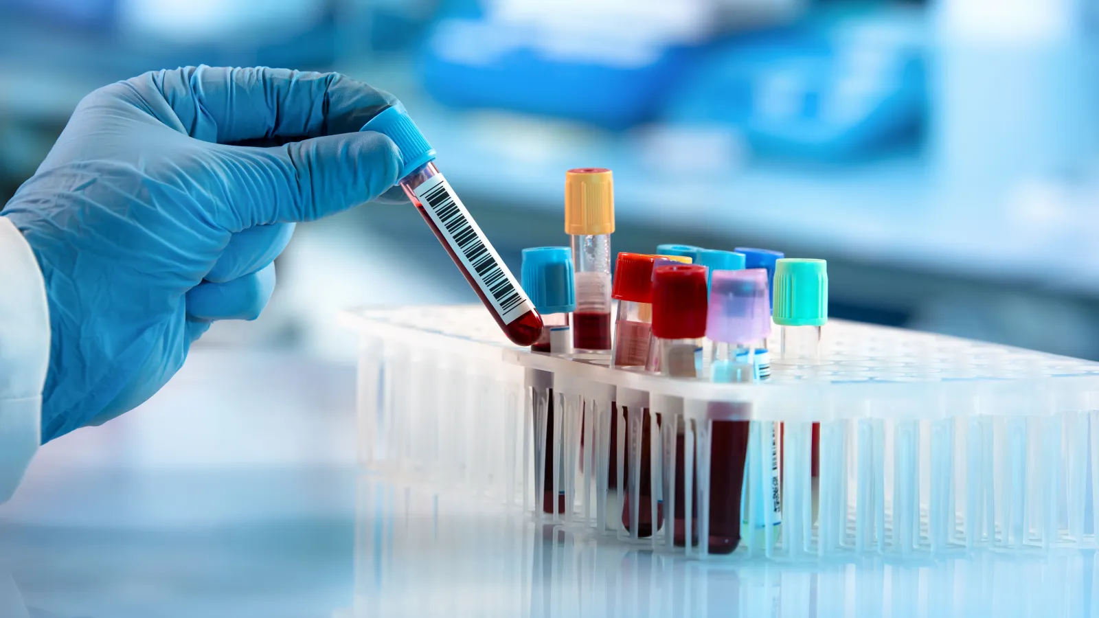 a person in a lab coat holding a syringe