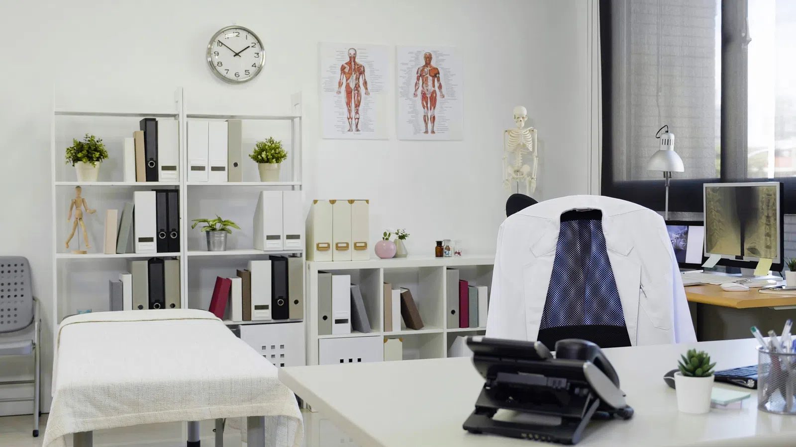 a white desk with a chair and a computer on it