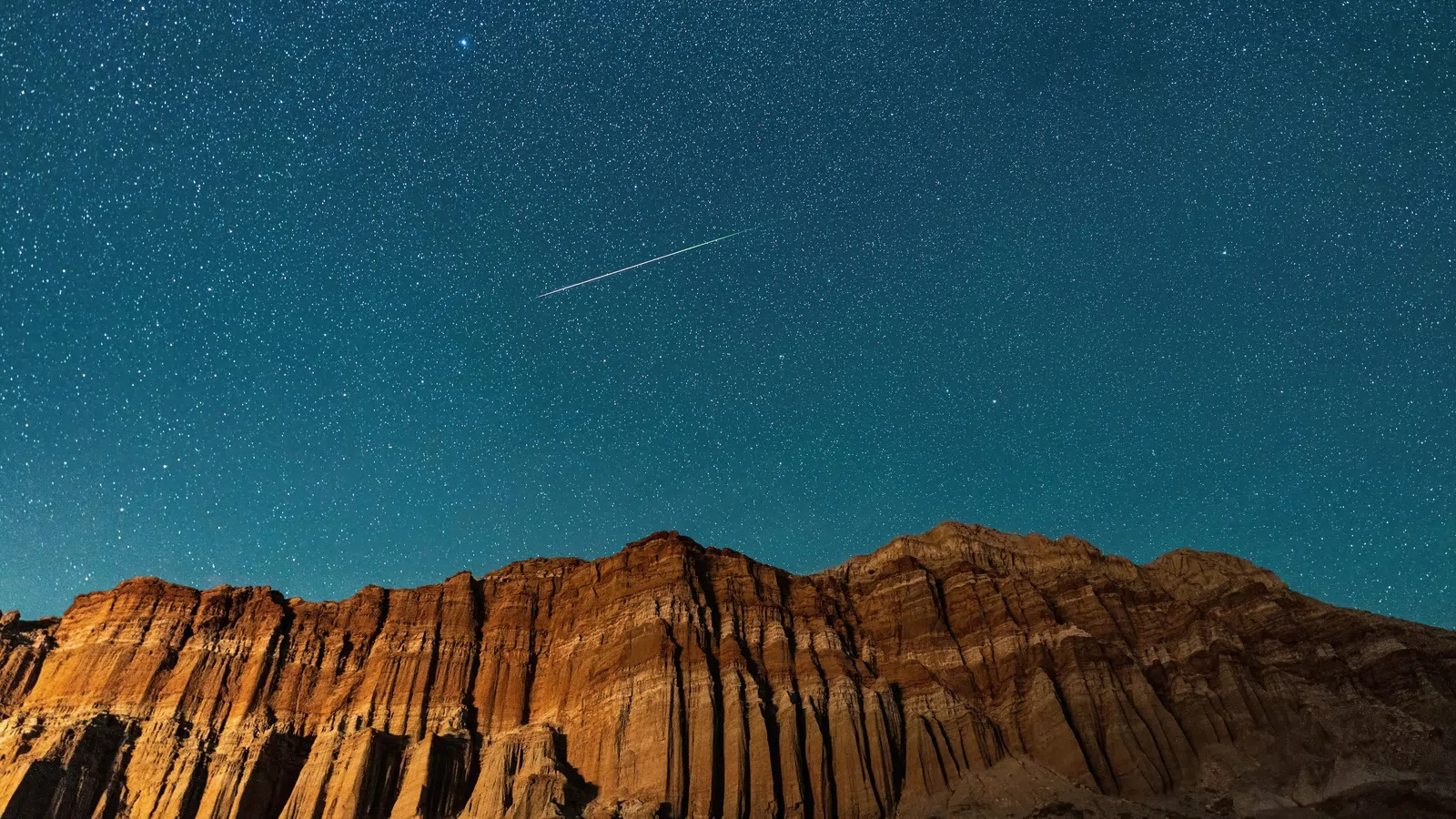 a mountain with a trail of smoke