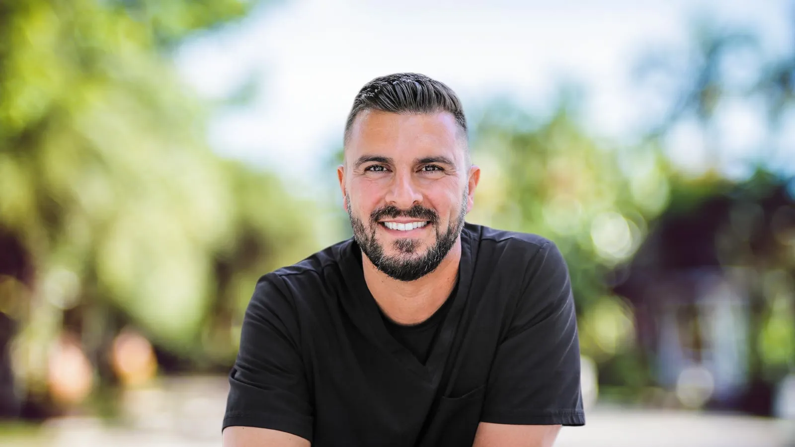 a man with a beard smiling
