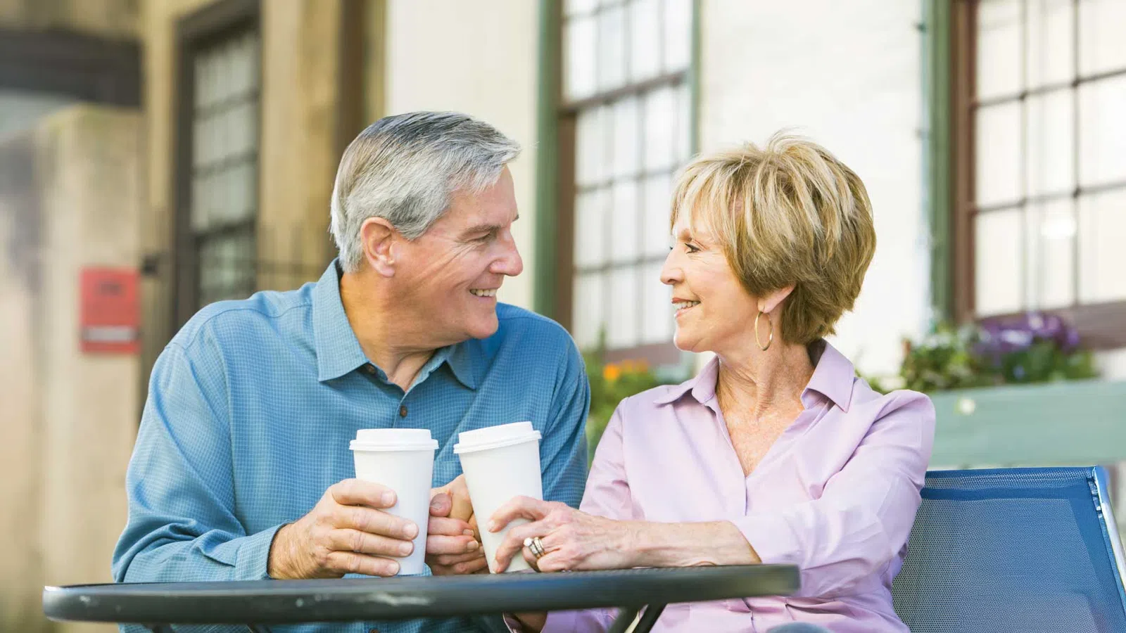 a man and a woman sitting at a table and smiling