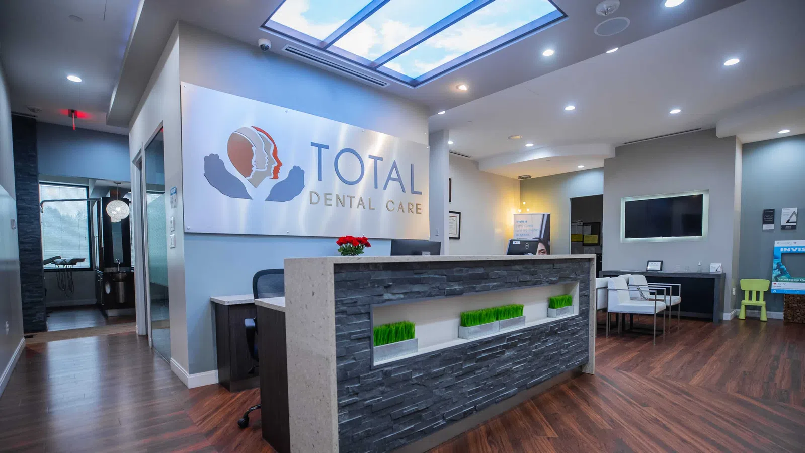 Modern dental office reception area with wood flooring
