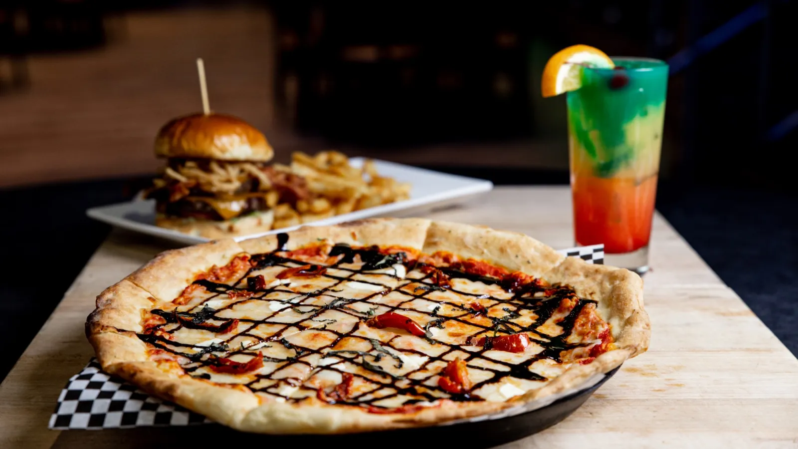 a pizza sitting on top of a wooden table
