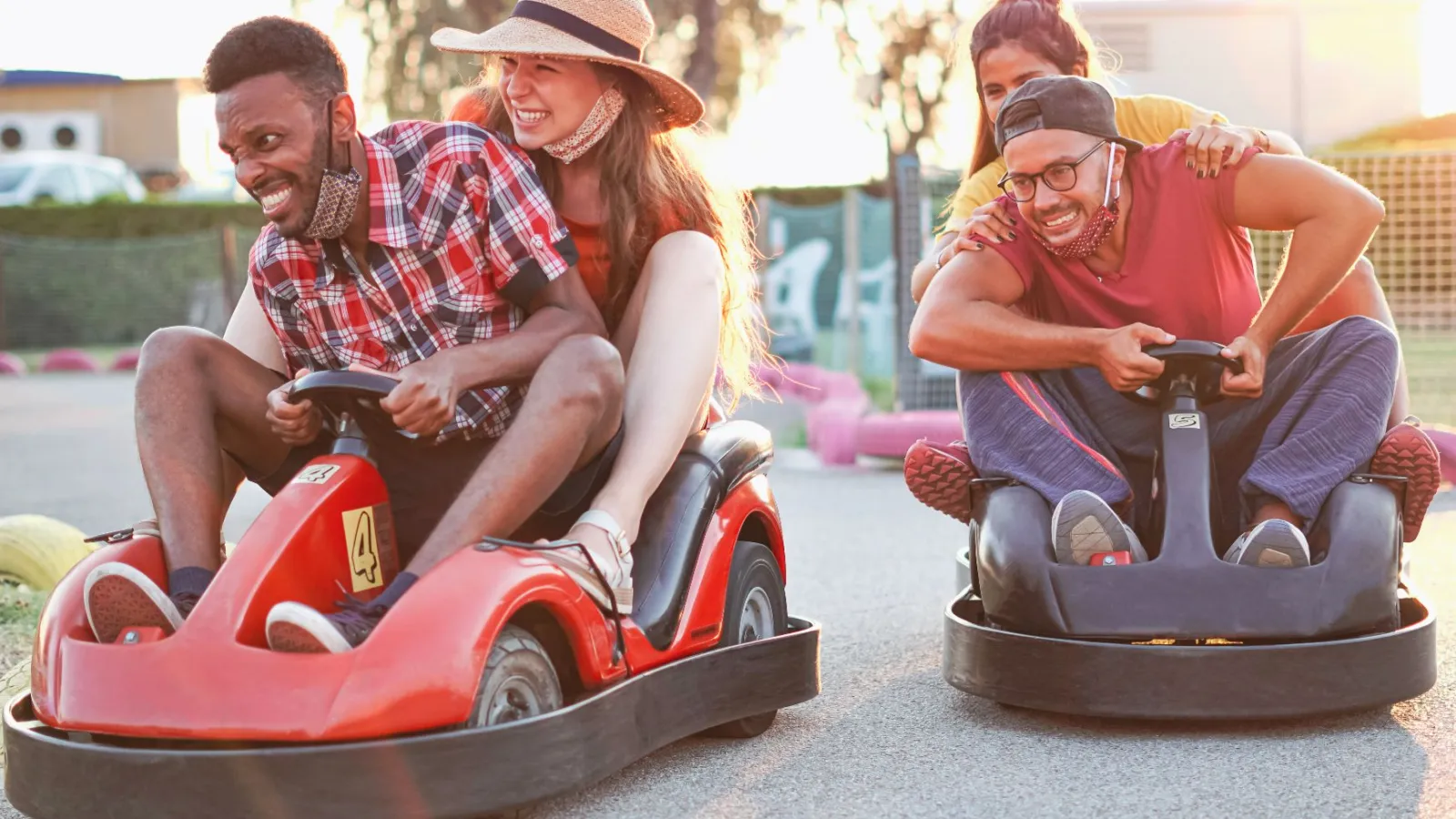 a group of people riding toy cars