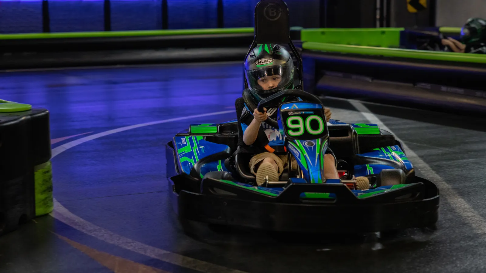 a couple of people in a go kart on a track