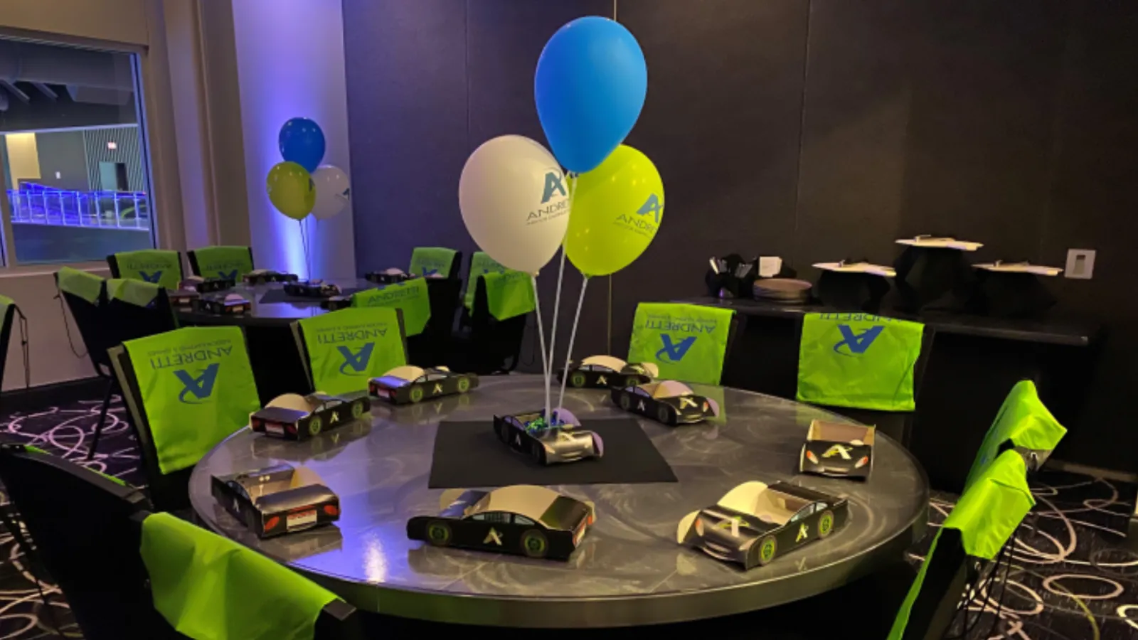 a room with balloons and cars