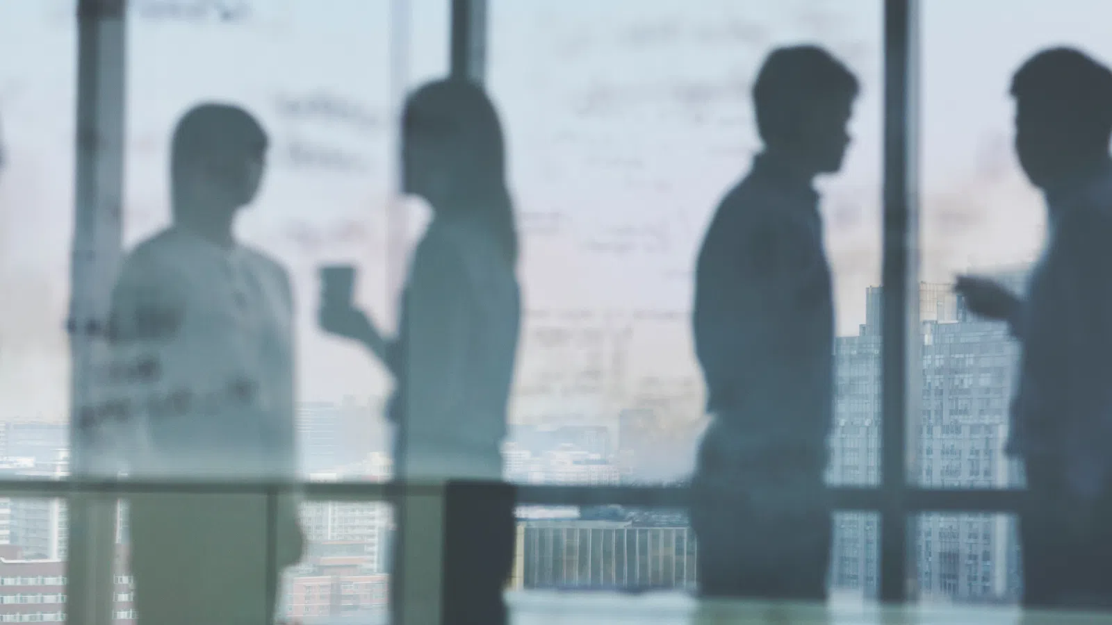 a group of people standing in front of a window